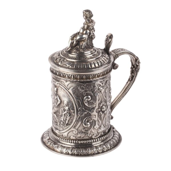 Lot 0081 <br/>A Russian baroque cast silver-gilt mug with a lid crowned by Bacchus figure <br/>Estimate: 6000-8000€