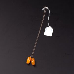 Amber "shoes" pendant with silver chain. — image 1