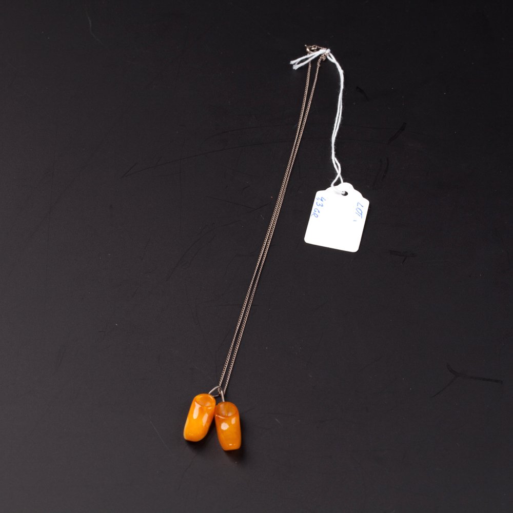 Amber "shoes" pendant with silver chain. — image 1