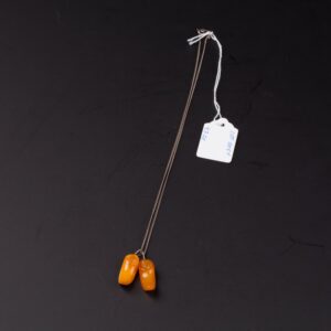 Amber pendant in the shape of shoes. — image 1