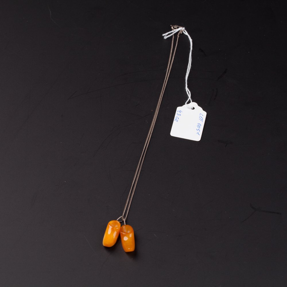 Amber pendant in the shape of shoes. — image 1